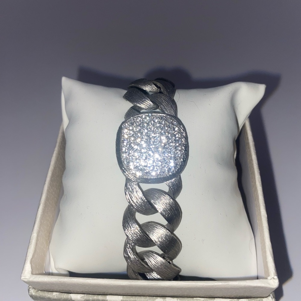 Brushed silver, chain-link, multiple rhinestone bracelet. Magnetic closure.